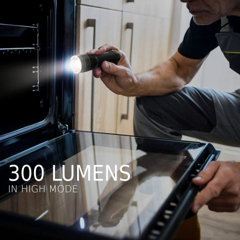 Man using Four Pack LED Tactical Flashlights S300 Pro IPX4 Waterproof Beefy Bright EDC Torches for inspecting oven.