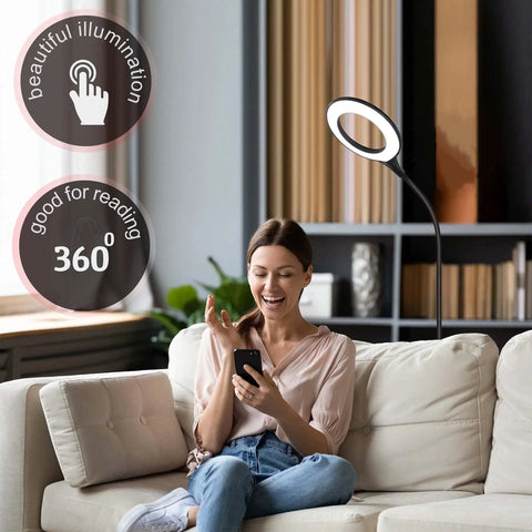 Woman sitting on a sofa using a smartphone next to a Gooseneck LED Floor Lamp For Office Reading And Bedrooms Non Glare Eye Safe Lighting 600 Lumens From 3 Watt LED Energy Saver Lit Brightness