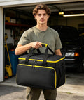 Slick Steam Cleaner Carry Case Featuring Dang Generous Internal Pockets And Hassle Free Straps For Keeping Your Floor Steamer Nozzles And Hoses Super Tidy Anywhere, black with yellow accents, portable, held by a man.