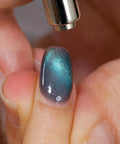 Mystic Galaxy 9D Cat Eye Gel Nail Polish Set With Jelly Cat Eye Effect being applied with magnetic tool