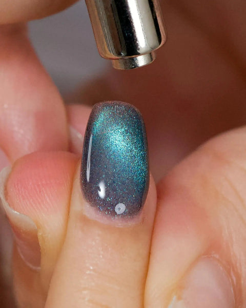 Mystic Galaxy 9D Cat Eye Gel Nail Polish Set With Jelly Cat Eye Effect being applied with magnetic tool