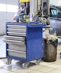 Blue tool cabinet on heavy duty steel casters in garage.