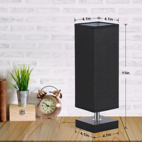 Modern Wood Table Lamp For Bedroom And Nightstand With Square Fabric Shade, 11in tall, on desk next to clock and plant