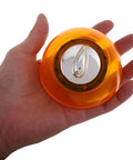 Hand holding orange Mechanical Kitchen Timer Wind Up Countdown Clock For Cooking And Baking No Fuss Meal Prep And Home Office Use
