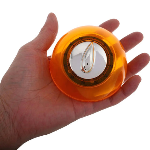 Hand holding orange Mechanical Kitchen Timer Wind Up Countdown Clock For Cooking And Baking No Fuss Meal Prep And Home Office Use