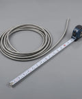 Heavy Duty Stainless Steel Bendable Conduit Sleeve For Weatherproof Cable Management With Measuring Tape On Gray Background