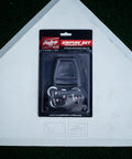 Umpire Gear Kit With 4-Dial Indicator, Plate Brush, And Pro-Style Cloth Bag packaged on a baseball home plate background.