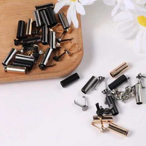 24 Pack Pro Grade Metal Cord End Caps For Shoelaces And Drawstrings, laying on wood surface, varied colors and durable zinc alloy