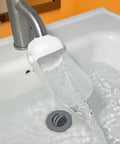 Universal Faucet Extender For Bathroom Sink And Kitchen Tap With Soft Spray Aerated Nozzle And Anti Splash Guard pouring water.