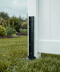 Heavy Duty Fence Post Repair Kit And Quick Fix Stabilizer Bracket installed on a white fence post in rain, providing support.