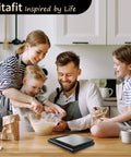 Family baking in kitchen with 11 lb Digital Food Scale with Pro Grade Precision 0.0001 lb stainless steel kitchen scale displayed.
