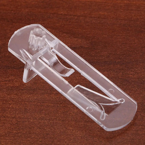 Clear plastic shelf support peg on wooden surface, part of 30 Pack Plastic Shelf Support Pegs for Wood and Glass Shelves, Easy Install.