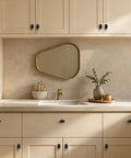 10 Pack Oval Zinc Alloy Cabinet Knobs With Straight Up Matte Black Finish on beige kitchen cabinets and sink area.