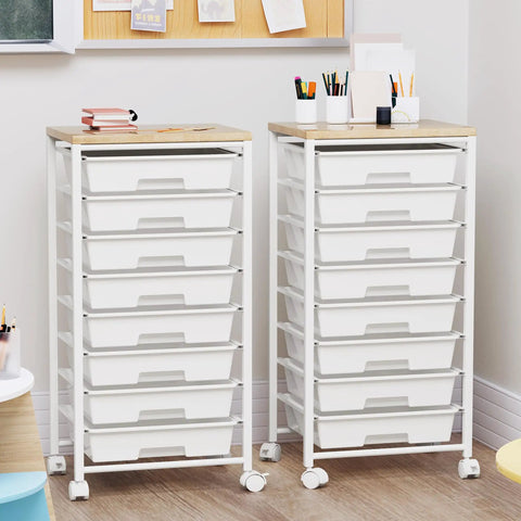 Two white rolling carts with eight drawers, wooden tabletop, and lockable wheels in a craft room with supplies on top.
