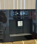 Next Level Built In Fully Automatic Coffee Maker With Glossy Black Glass Panel And Smart Touchscreen Interface brews hassle free espresso.