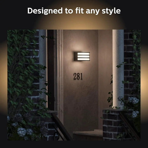 Hue Lucca White Outdoor Wall Light With Dusk To Dawn Sensor illuminating a porch at night with house number 281 visible
