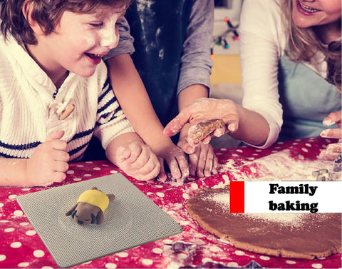 Group of children baking together with dough on a red polka dot tablecloth and a rolling toy on a mat.