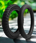 12 Inch Bike Tire And Inner Tube Set 12x2.125 With AV Valve Puncture Resistant Rubber Outer Tire displayed on a sunny path