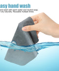 Hand washing a gray cloth from 10 Pack Microfiber Cleaning Cloths For Electronics, Camera Lenses, Eyeglasses, Phones And Laptops