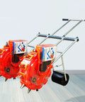 Hand Seed Spreader And Fertilizer Applicator, Double Row Manual Seeder with roller drive, metal frame in garden setting