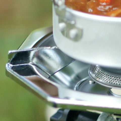 Close-up of BottleTop Propane Stove Portable Camping Cooker with adjustable burner and wind baffles for steady cooking.