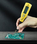 Hand holding yellow digital multimeter with LED clip probes testing a PCB for resistance, capacitance, diodes, and LEDs.