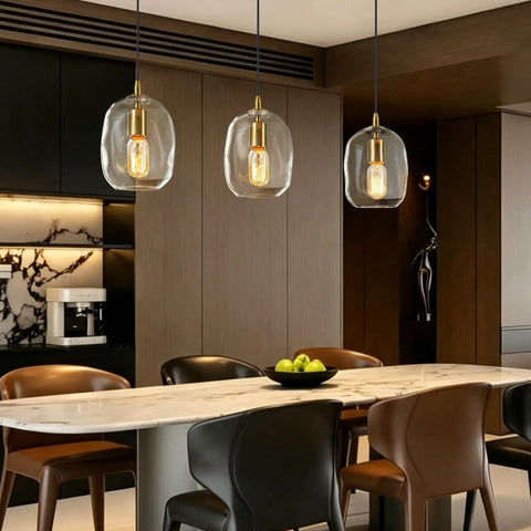 Pendant Lights Kitchen Island, Hand-Blown Clear Glass Brass Gold 9 Inch H, three lights above a dining table with dark wood background.
