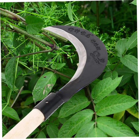Manganese Steel Hand Scythe For Weeding And Cultivation With Comfortable Grip One Handed Garden Tool in action among green plants