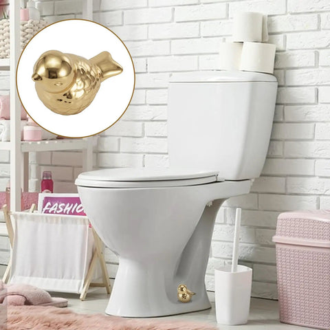 Two Pack Gold Bird Toilet Bolt Covers Decorative Screw Caps Glossy Finish on white toilet in stylish bathroom setting.