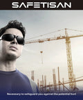 Man wearing Bulk 48 Pack Tinted Safety Glasses With Smoke Lenses, UV Protection on construction site background.