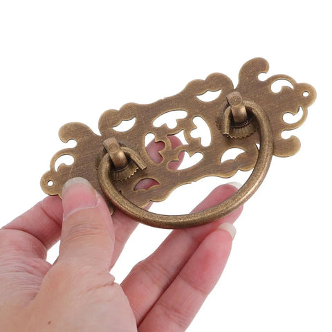 Two Pack Vintage Brass Drawer Pulls Handles For Dressers And Wardrobes, Retro Bronze Cabinet Knobs With Old School Antique Style held by hand