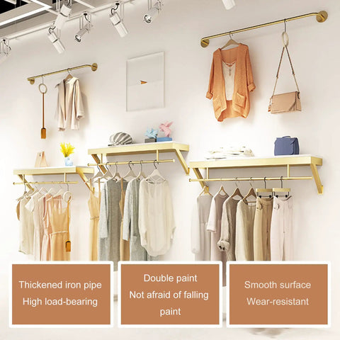 Top Shelf Wall Mounted Clothing Rack System Kit Crafted from Rock Solid Wrought Iron Pipes and Rugged Pine Boards for Boutique or Main Street Closets That Can Take Some Serious Wear and Tear in a showroom with clothing.