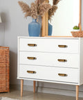 White dresser with 4 Pack Antique Zinc Alloy Cabinet Pulls With 3 Inch Hole Centers Brass Finish, used as cupboard handles.