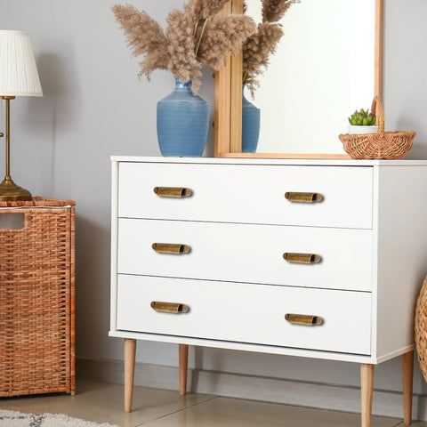White dresser with 4 Pack Antique Zinc Alloy Cabinet Pulls With 3 Inch Hole Centers Brass Finish, used as cupboard handles.