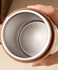 Interior view of Self Heating Coffee Mug With Quick Temperature Display And Totally Spill Proof Lid, showing the silver lining and grip.