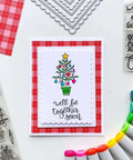 Rectangle Frame Metal Die Cuts Set With Scalloped Edges And Stitched Nesting Tags for DIY Scrapbooking on a Christmas card display.