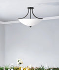 Geary Small Two Light Semi Flush Convertible Pendant Light In Midnight Black Modern Hanging Fixture in dining room setting.