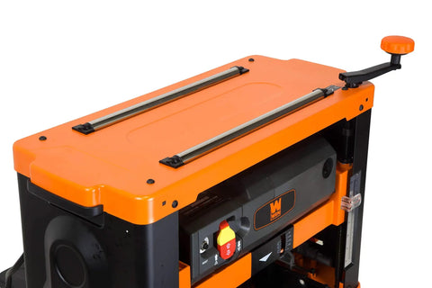 Close-up of Garage Ready Spiral Benchtop Thickness Planer control panel and adjustment knobs with orange and black finish.