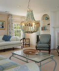 Three Light Wood Beaded Chandelier in Rustic Farmhouse Vibe hanging in a cozy living room with vintage decor.