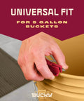 Hand securing Universal 5 Gallon Bucket Trowel Scraper For Tile Work With Stainless Steel Edge Guard on bucket rim.
