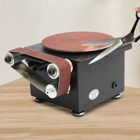 Versatile Mini Belt Disc Sander With 6-Inch Sanding Wheel And Small Grinder For Wood Metal Working in use with scissors.