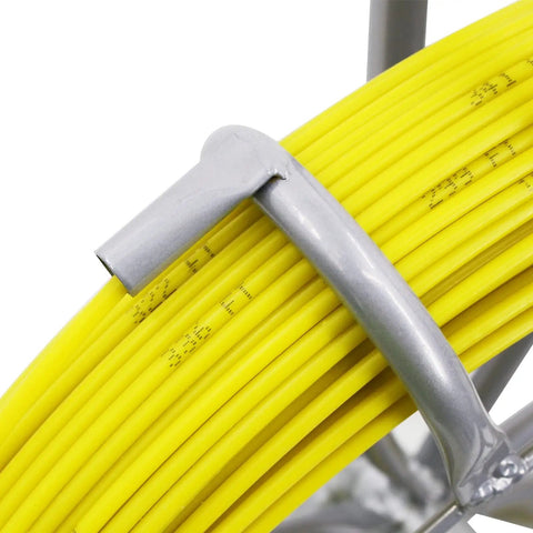 Close-up of gray hook on yellow fiberglass rod of 6mm diameter on a steel reel, part of Fiberglass Duct Rod Fish Tape Puller Kit with 450 feet.