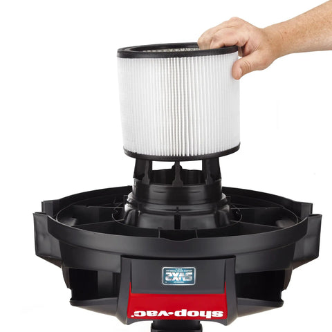 Hand placing Pleated Cartridge Filter Replacement For Wet Dry Vacuums, 8 Inch Diameter By 6.5 Inch Height onto vacuum base