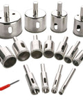 Front view of 15-piece diamond hole saw kit with arbors for plant pots; metal cutters and a small red screwdriver