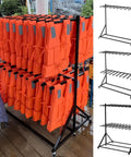 Heavy Duty Wheeled Life Jacket Storage Rack Holds Up To Forty Flotation Vests Easy Rolling Black Steel Organizer displaying orange vests.