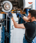 Mechanic wearing Six Pairs Latex Coated Palm Work Gloves With Seamless Knit Lining For Superior Grip using impact wrench on car wheel
