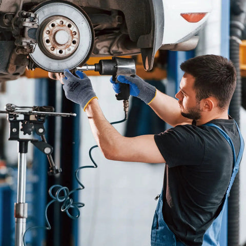 Mechanic wearing Six Pairs Latex Coated Palm Work Gloves With Seamless Knit Lining For Superior Grip using impact wrench on car wheel