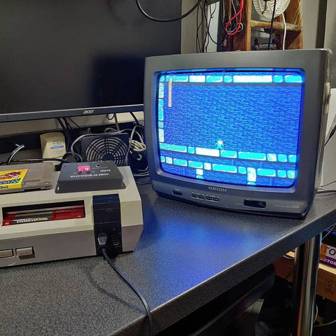 Retro gaming setup with RCA To Coax RF Modulator Converter With Channel Switch for TV Tuner, Nintendo console, and CRT monitor.