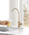 Top Shelf Champagne Bronze Kitchen Water Filter Faucet Built To Drop Right Into Most Reverse Osmosis Systems drawing crisp water into a glass.