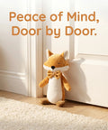 Fox Shaped Plush Door Stopper With Cotton Filling beside white door on wooden floor, heavy duty proofing pinch guard visible.